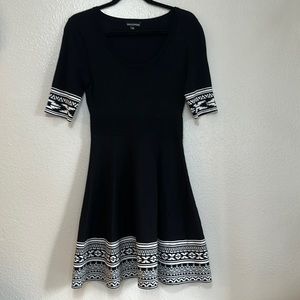 Black knit midi short sleeve dress with an oval neck black and white pattern